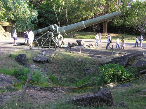 Corregidor Island World War II gun with bomb crater in foreground.